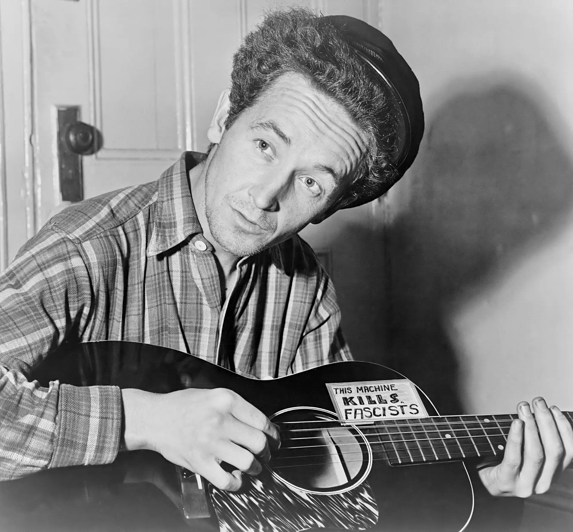 Woody Guthrie, his hero, whom he visited in hospital soon after reaching New York (photo 1943)